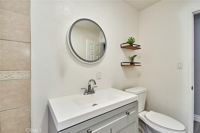 bathroom featuring vanity and toilet