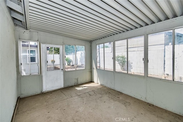 unfurnished sunroom featuring a wealth of natural light and lofted ceiling