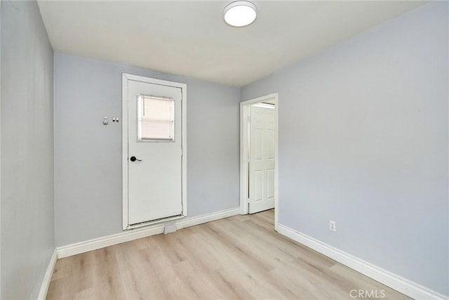 unfurnished room with light wood-type flooring