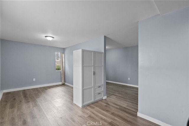 unfurnished room with wood-type flooring