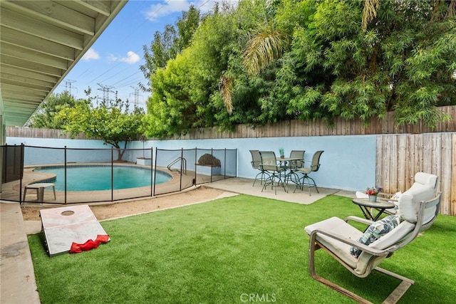 view of swimming pool with a lawn and a patio area