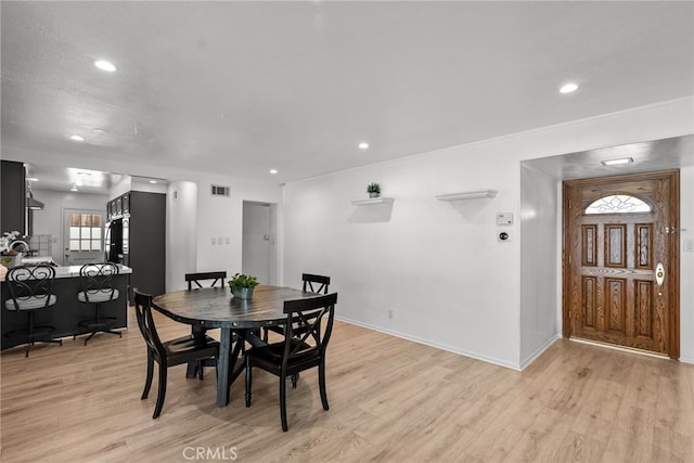 dining room with a healthy amount of sunlight and light hardwood / wood-style floors