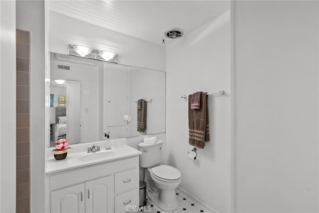 bathroom featuring vanity and toilet