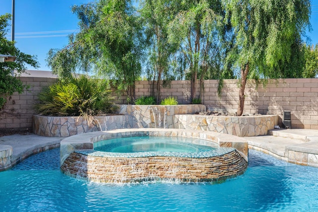 view of swimming pool with an in ground hot tub and pool water feature