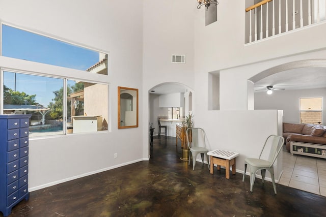 entrance foyer with a high ceiling and ceiling fan