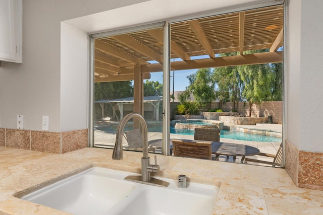 exterior space with a pergola, sink, and a fenced in pool