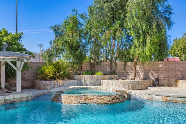 view of swimming pool featuring an in ground hot tub and pool water feature