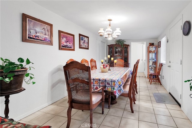 dining room with an inviting chandelier and light tile patterned floors