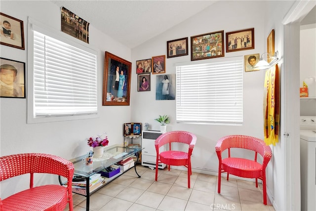 sitting room with lofted ceiling, washer / clothes dryer, and tile patterned floors