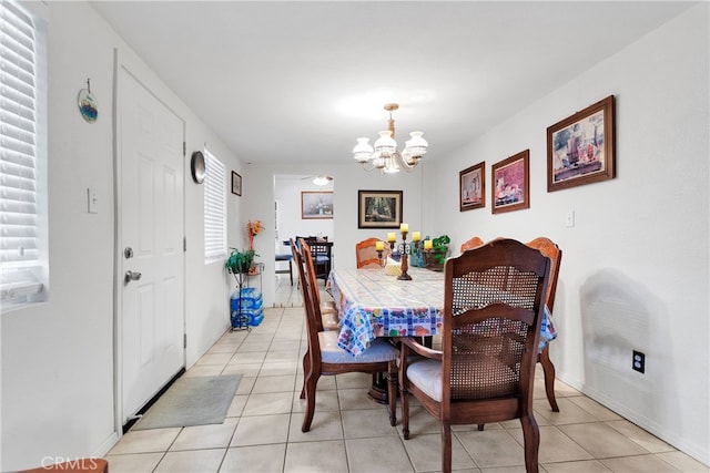 dining space featuring an inviting chandelier and light tile patterned floors