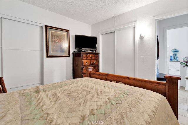 tiled bedroom featuring a textured ceiling