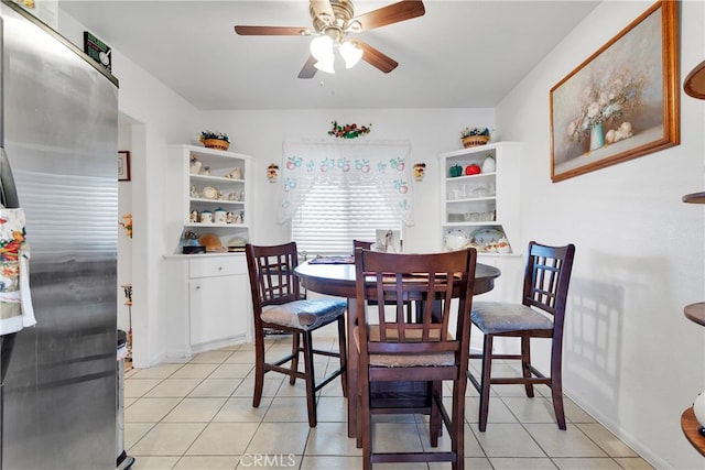 tiled dining space with ceiling fan