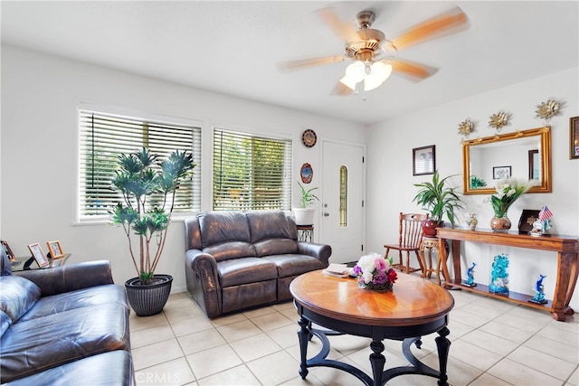 living room featuring light tile patterned flooring, ceiling fan, and a wealth of natural light