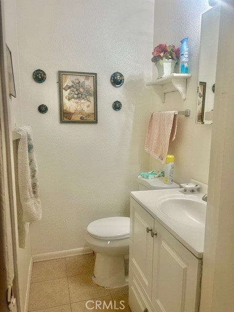 bathroom with tile patterned floors, vanity, and toilet