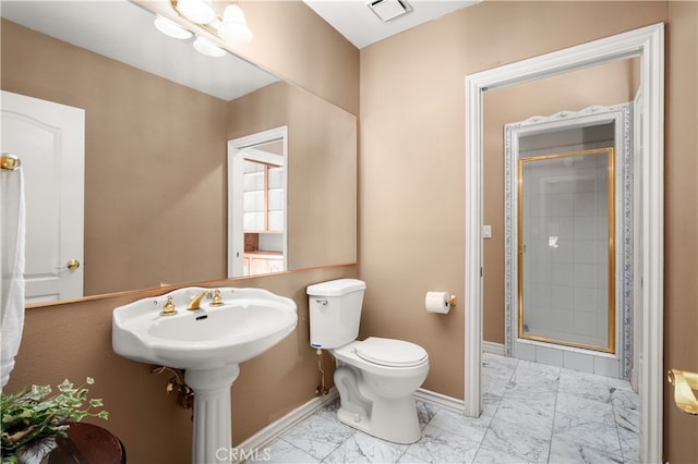 bathroom featuring toilet and walk in shower