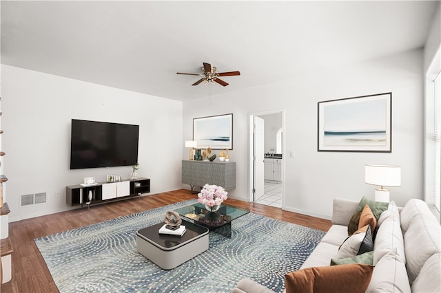 living room featuring ceiling fan and hardwood / wood-style flooring