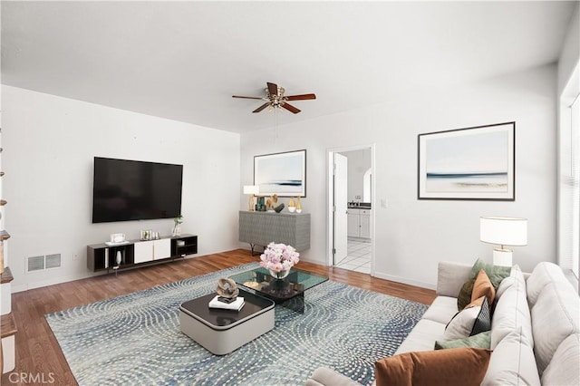 living area featuring ceiling fan, wood finished floors, and visible vents