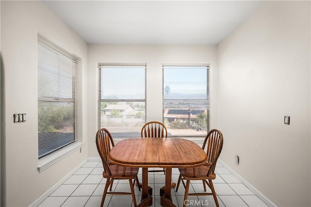 dining space with light tile patterned floors and baseboards