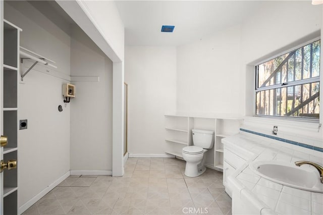 full bathroom with plenty of natural light, baseboards, toilet, and vanity
