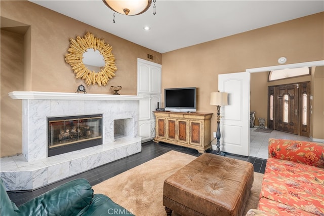 living room featuring dark wood-type flooring and a fireplace