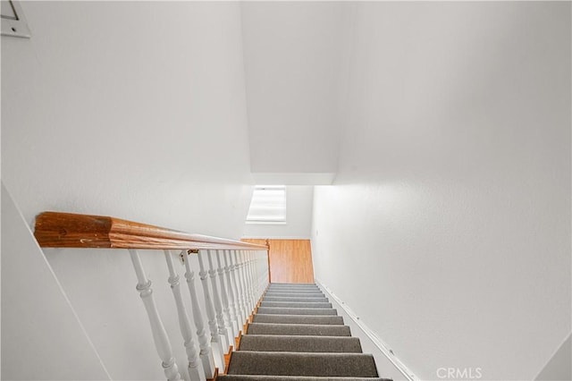 stairs with baseboards and wood finished floors