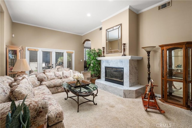 living room with ornamental molding, a fireplace, and visible vents