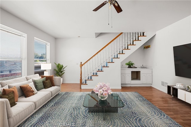 living room featuring hardwood / wood-style floors and ceiling fan