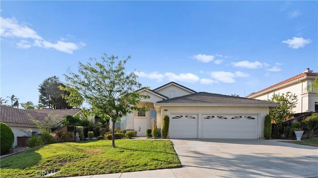 ranch-style home featuring a front lawn and a garage