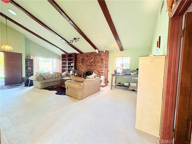 living area featuring a healthy amount of sunlight, carpet flooring, and lofted ceiling with beams