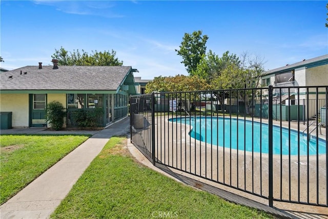 view of swimming pool with a yard and a patio area