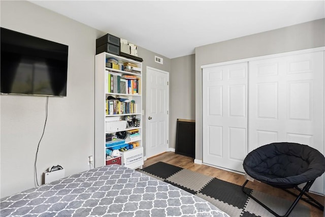 bedroom with a closet and hardwood / wood-style flooring