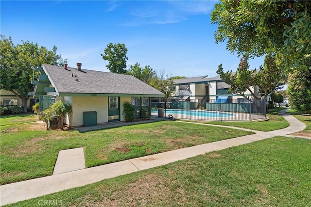 exterior space featuring a pool and a yard