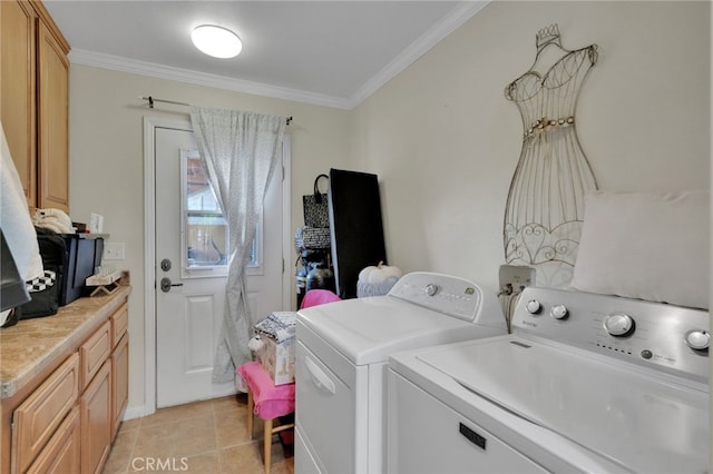 washroom featuring washing machine and clothes dryer, light tile patterned flooring, cabinets, and ornamental molding