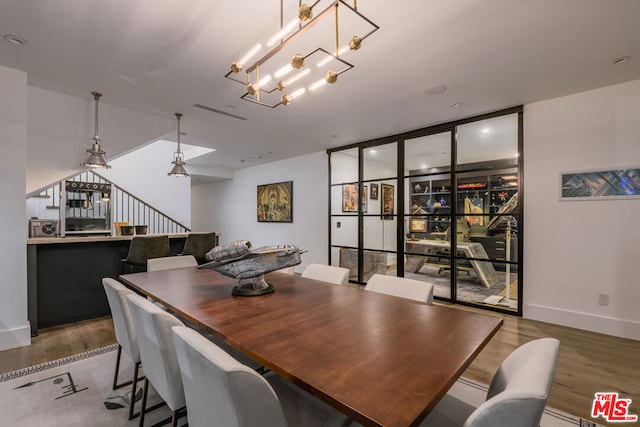 dining room with a chandelier and hardwood / wood-style floors