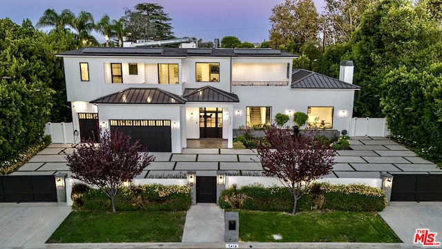 view of front facade with solar panels and a lawn