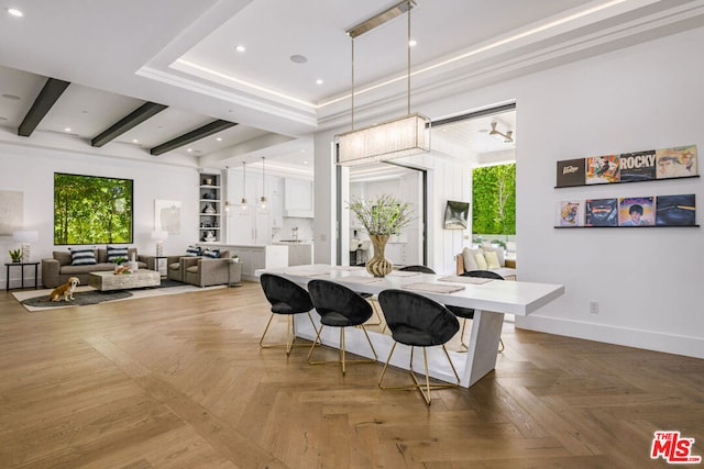 kitchen with parquet floors, a breakfast bar, ceiling fan, pendant lighting, and white cabinetry