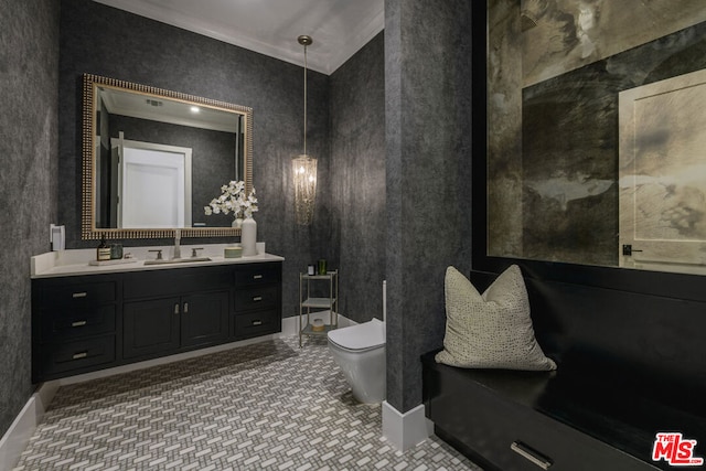 bathroom featuring tile patterned floors, crown molding, vanity, and toilet