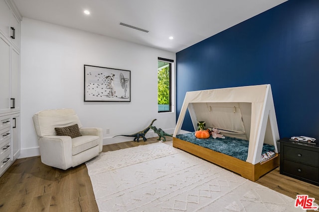 bedroom with hardwood / wood-style floors