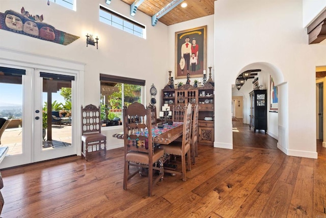 dining room featuring a high ceiling, dark hardwood / wood-style flooring, wood ceiling, and french doors