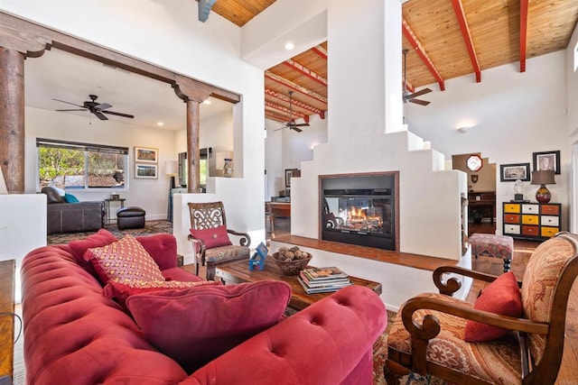 living room with beam ceiling, wood ceiling, and high vaulted ceiling