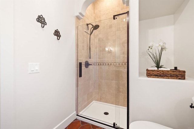 bathroom featuring a shower with shower door