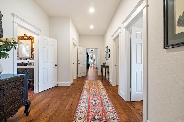 corridor with dark hardwood / wood-style floors