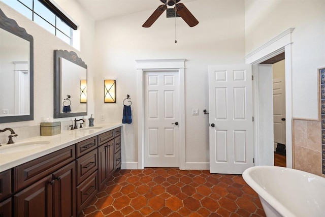 bathroom featuring ceiling fan, a tub to relax in, and vanity