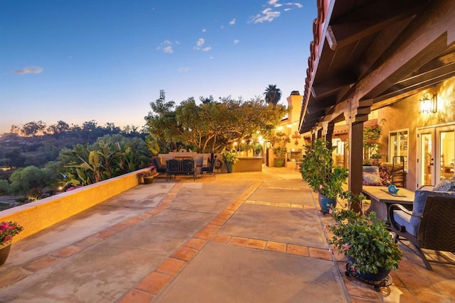 patio terrace at dusk featuring an outdoor living space