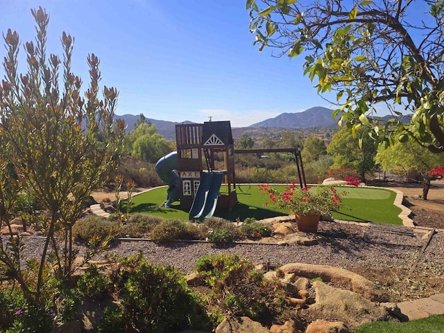 view of jungle gym featuring a mountain view