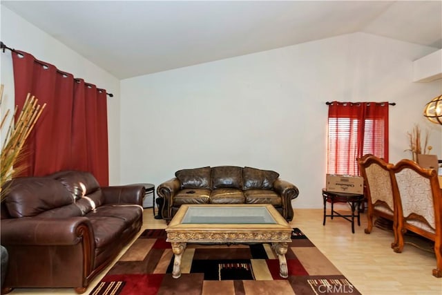 living room featuring a baseboard radiator, light hardwood / wood-style floors, and vaulted ceiling