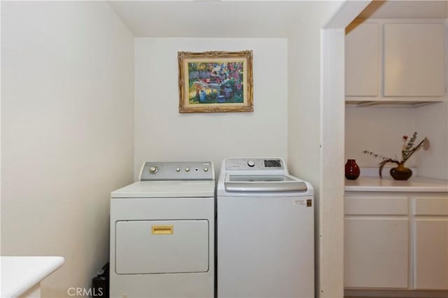 laundry area with cabinets and washing machine and dryer