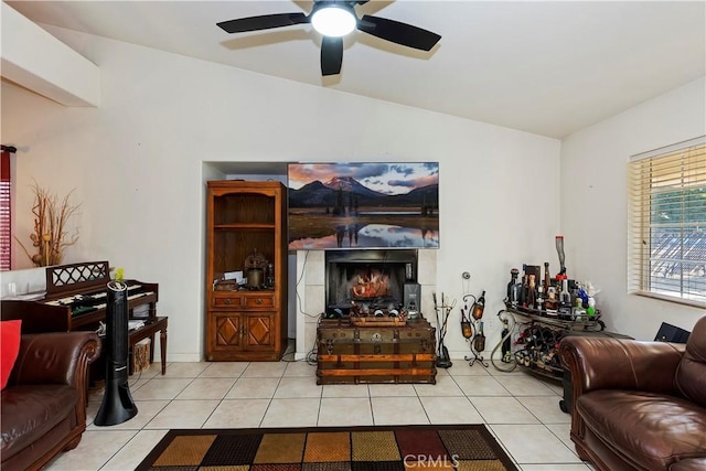 tiled living room with ceiling fan and lofted ceiling