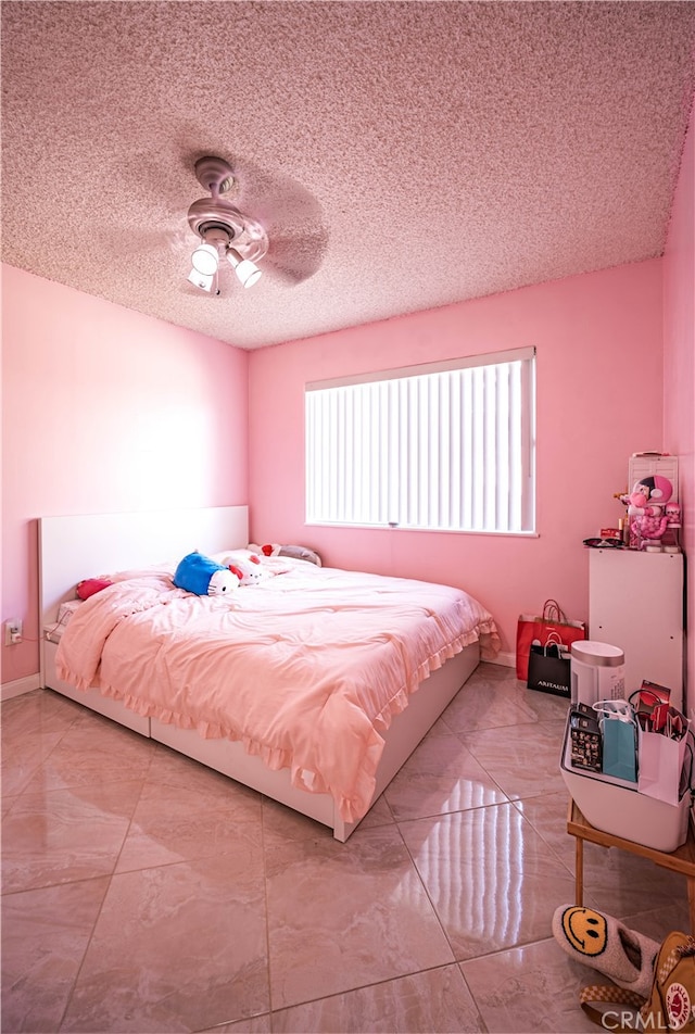 bedroom with a textured ceiling and ceiling fan