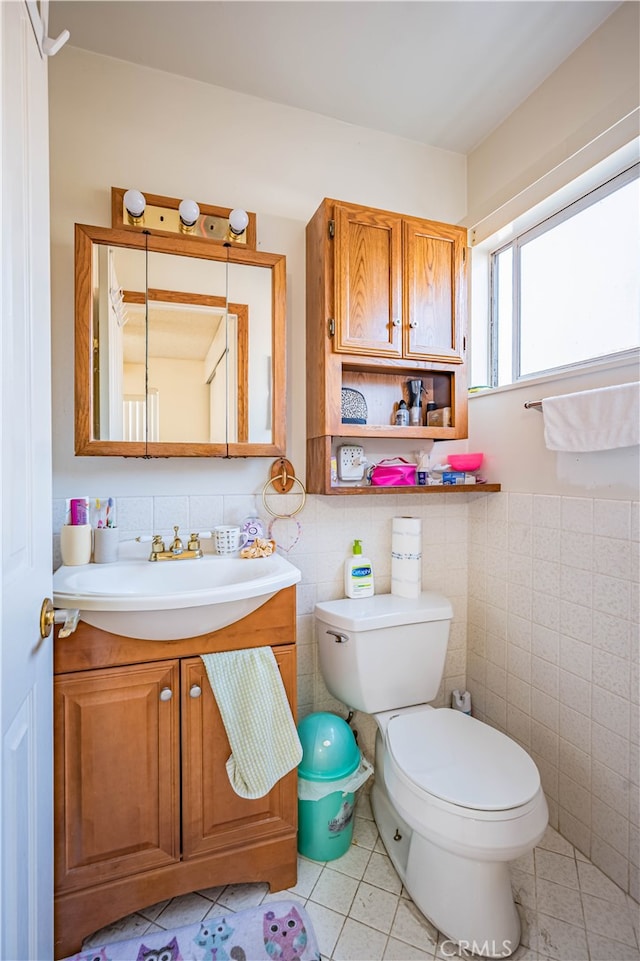 bathroom featuring tile walls, tile patterned flooring, vanity, and toilet